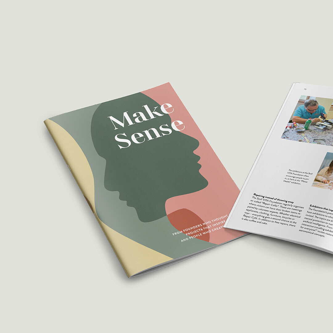 Magazine titled 'Make Sense' with a cover showing a green silhouette of a head on a pink background, open to pages featuring photos of people working at a table and a garden with buildings.