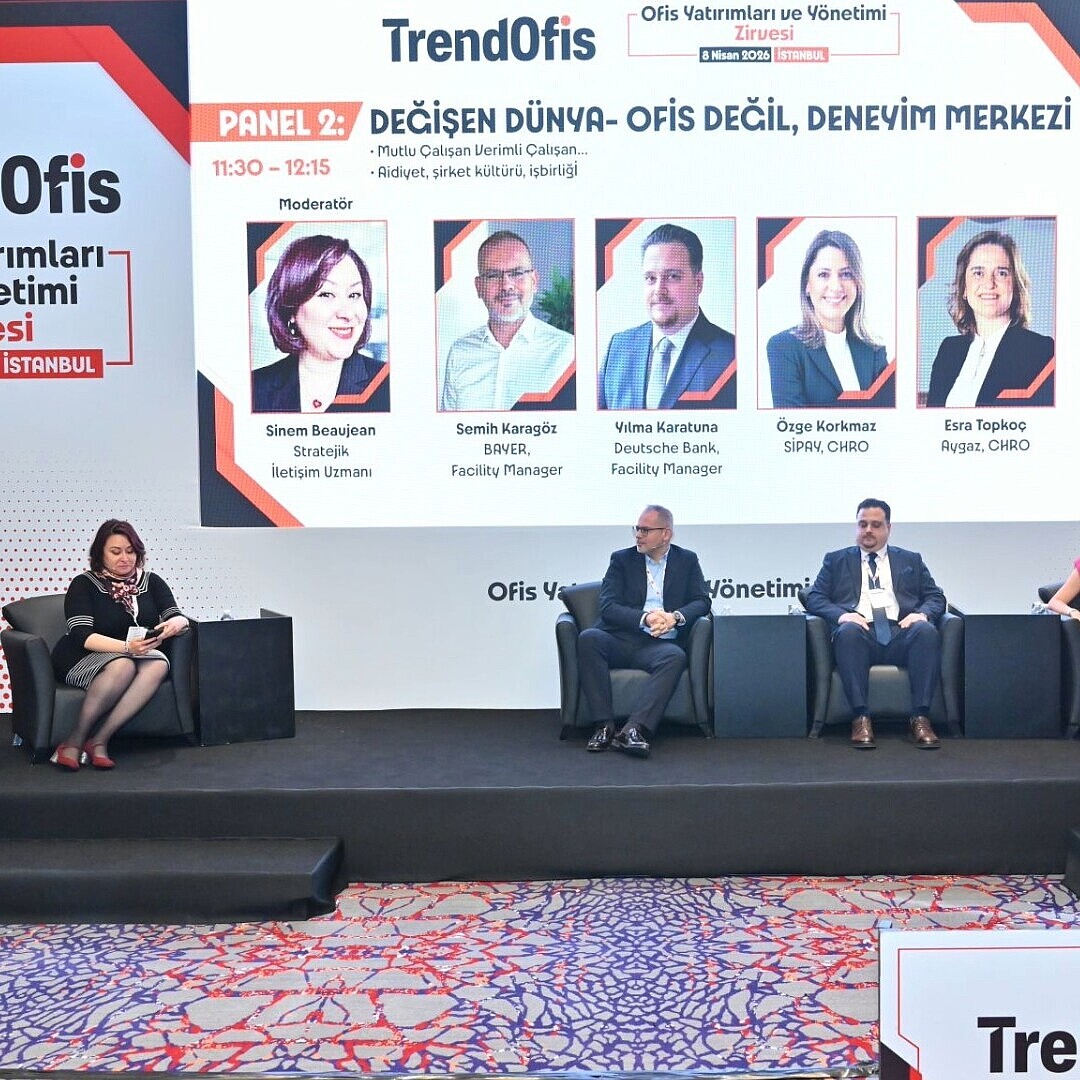 Podiumsdiskussion mit sechs Personen auf einer Bühne vor einer großen Leinwand mit dem Schriftzug 'TrendOfis' und Details zum Event 'Ofis Yatırımları ve Yönetimi Zirvesi' in Istanbul
