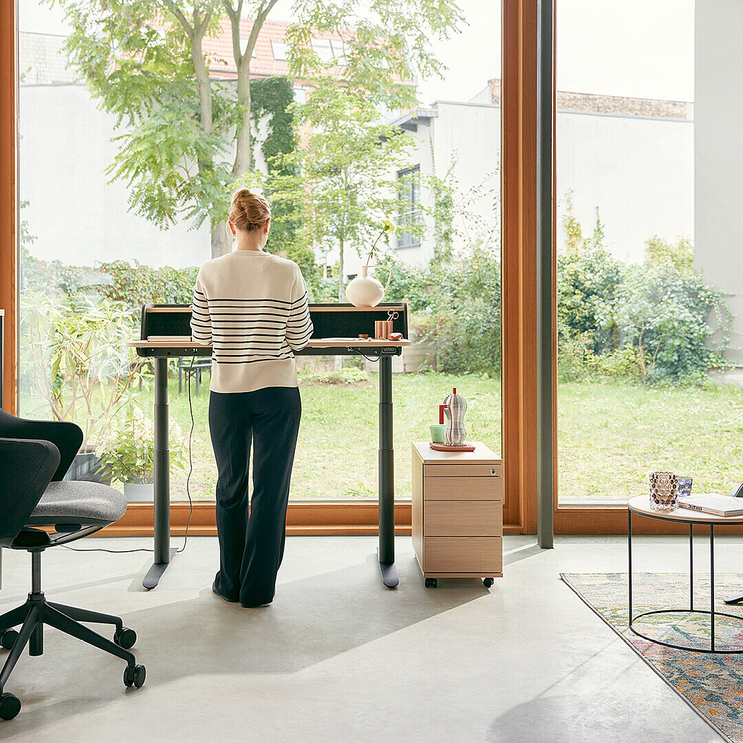 Woman works at desk in home office