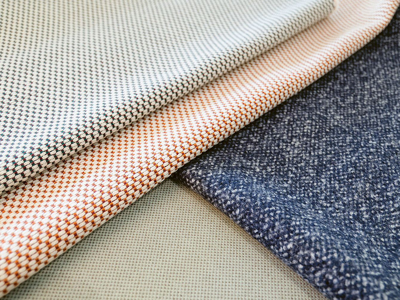 Close-up of various fabric samples showcasing different textures and patterns, highlighting the importance of material selection in design.