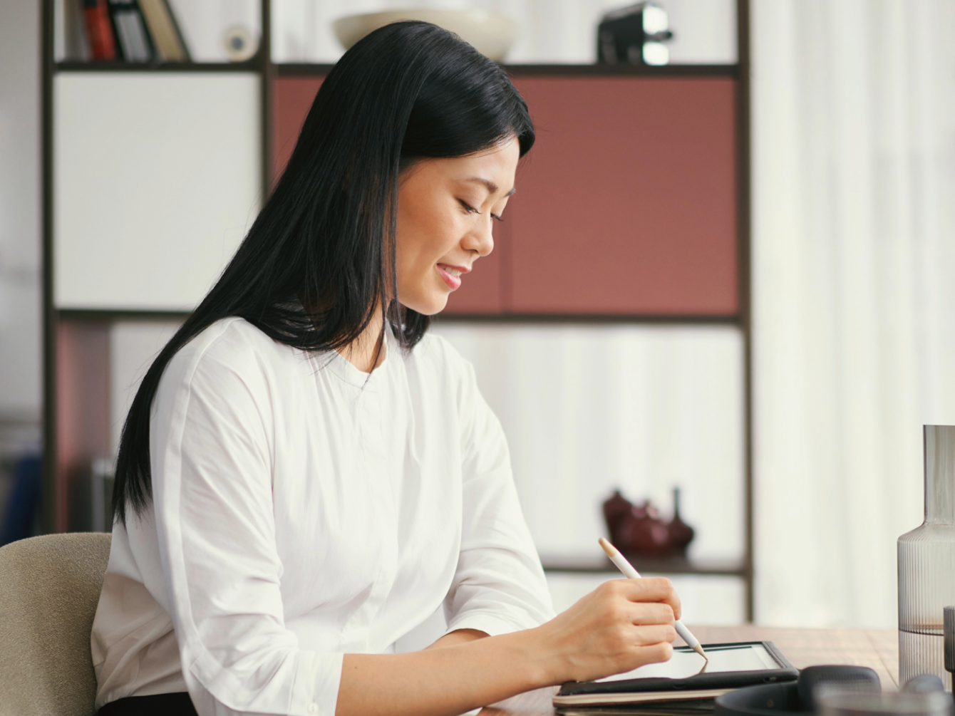 Woman at table working intently
